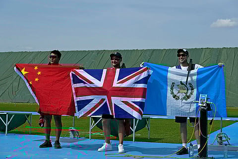 Men's Trap: Britain's Nathan Hales, center, with China's Qi Ying, left, and Guatemala's Jean Pierre Brol Cardenas